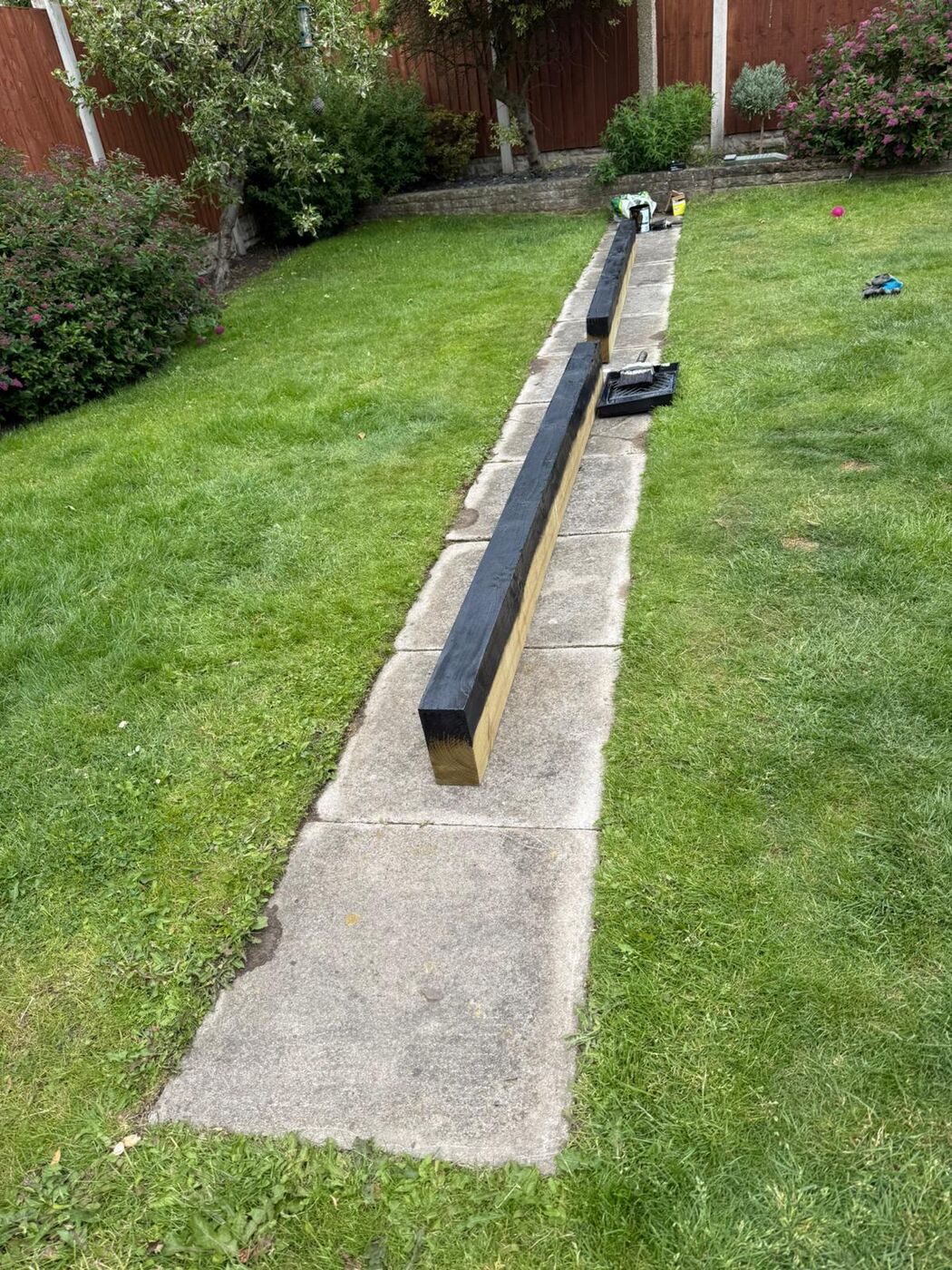 Crisp lawn edging and paving installed along a garden border